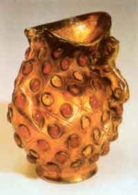 Gold cup with tiger-shaped handle and inlaid with agates dated to period contemporary with the Southern and Northern Dynasties, unearthed at Boma ancient cemetery, Zhaosu county, in the collection of the Ili Kazak Autonomous Prefecture Museum, Yining.