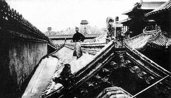 Fig. 5 Photograph showing Puyi on the roof of the imperial apartments, Forbidden City, with Prospect Hill, or Jing Shan, visible in the background.