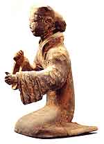 Fig. 21 
Pottery figurine of musician striking stone chimes
2nd century BCE